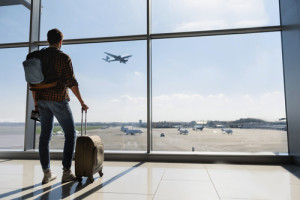 Male tourist looking at flight