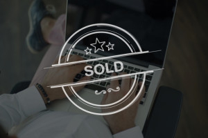 People Using Laptop and SOLD Concept