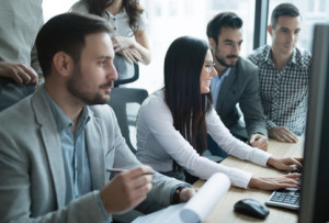 Software engineers working in office on project together