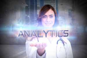 The word analytics and portrait of female nurse holding out open palm against urban projection on wall
