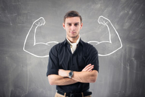 Young attractive ambitious businessman against the wall. Concept ambition, business, confident, powerful