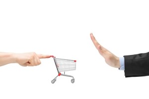 Finger pushing an empty shopping cart and male hand gesturing st