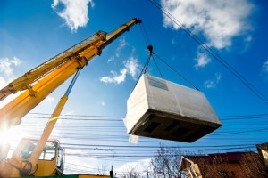 Industrial Crane operating and lifting an electric generator aga