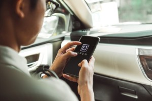 BANGKOK, THAILAND - JANUARY 22: A man using Uber app on smartpho