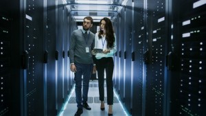 IT Specialist Showing Working Data Center with Rows of Rack Serv